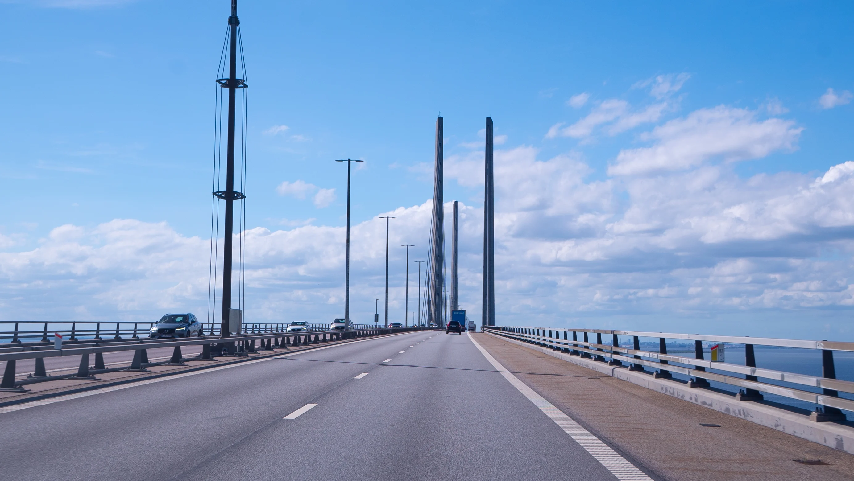 Car driving on the Øresund bridge towards the pylons.