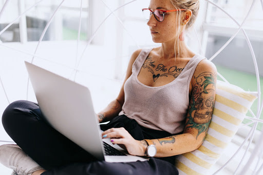 Tattoo girl using laptop