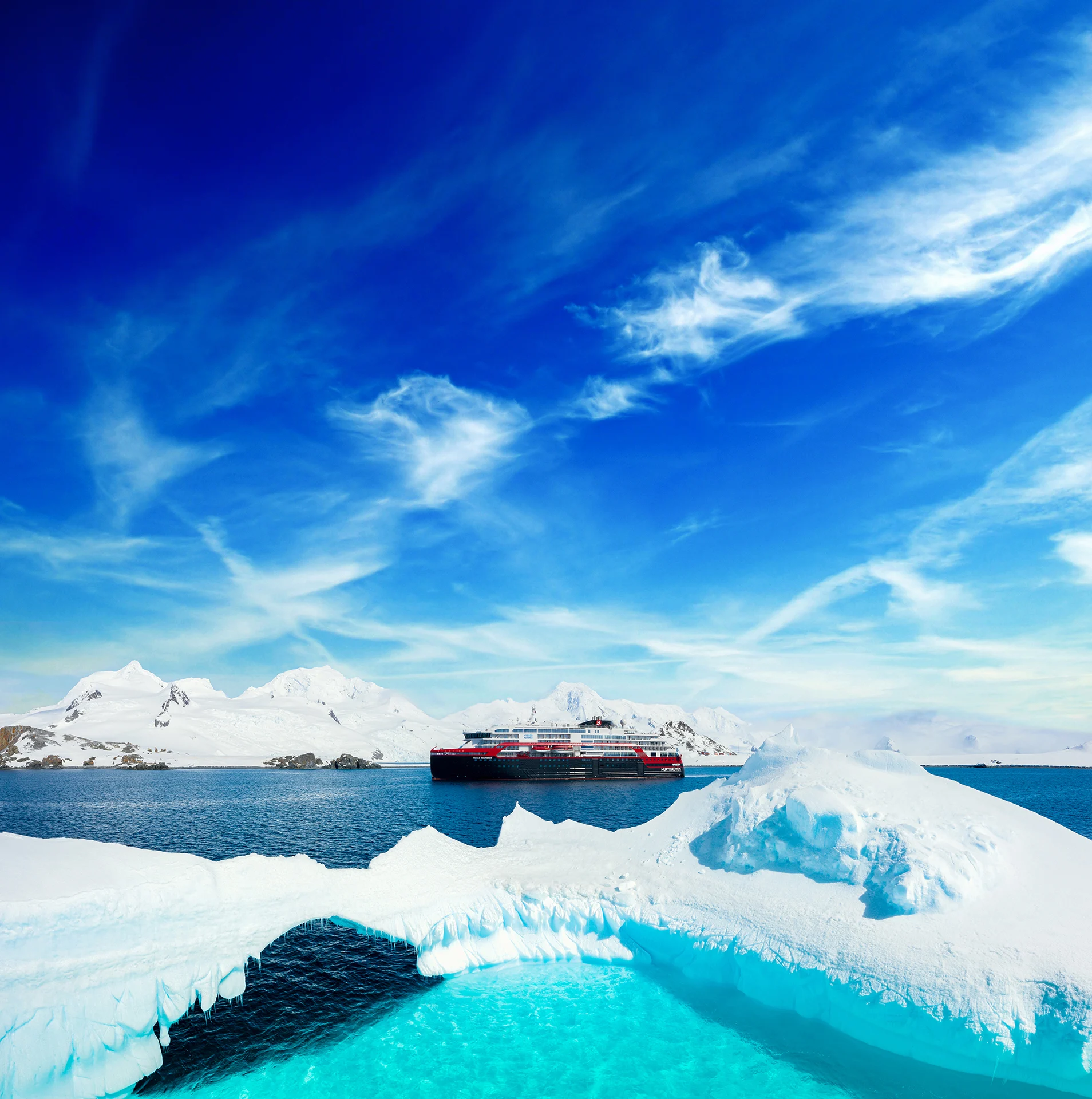 MS Roald Amundsen cruise ship sailing through icebergs in Antarctica