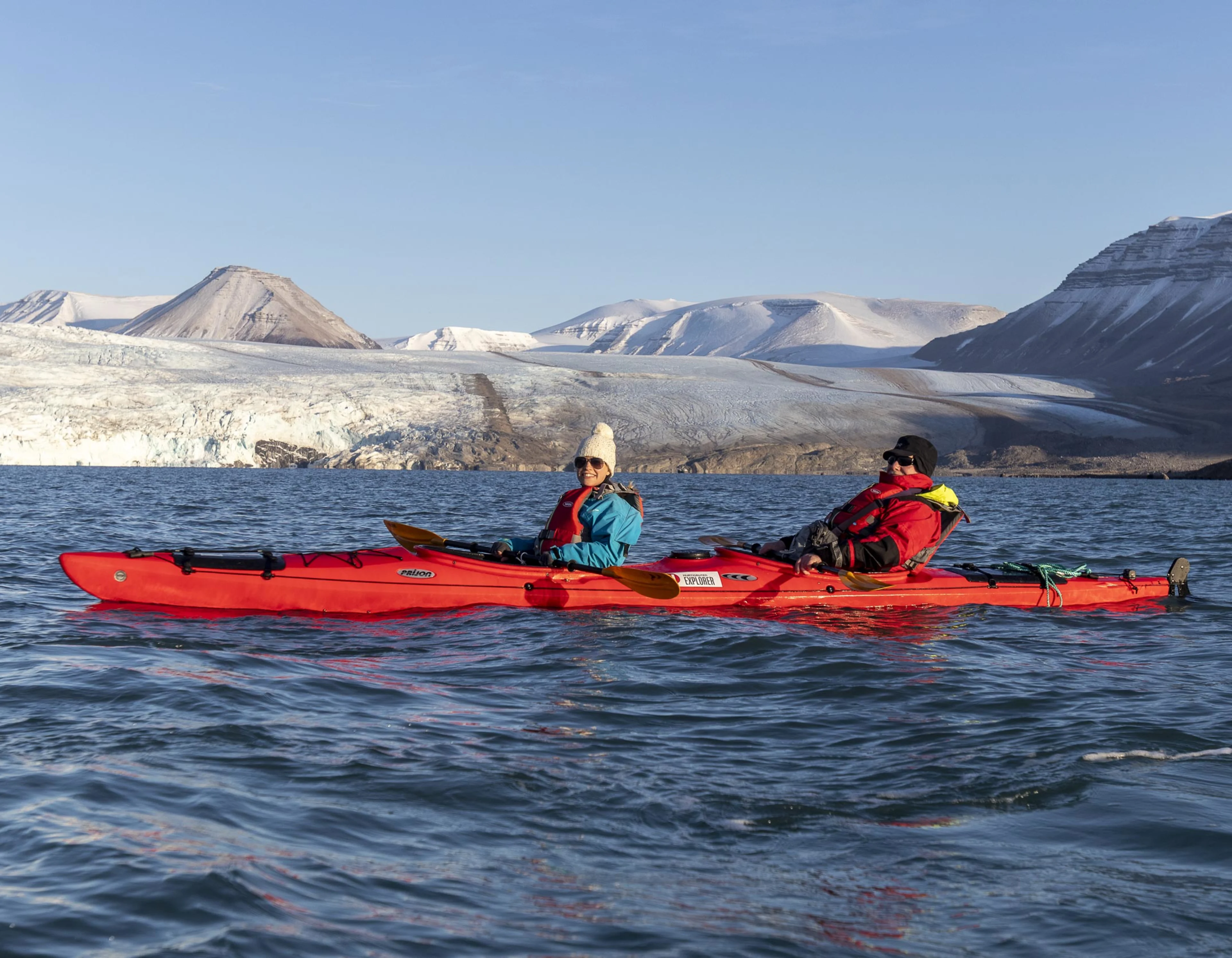 Expedition guests kayaking in Svalbard