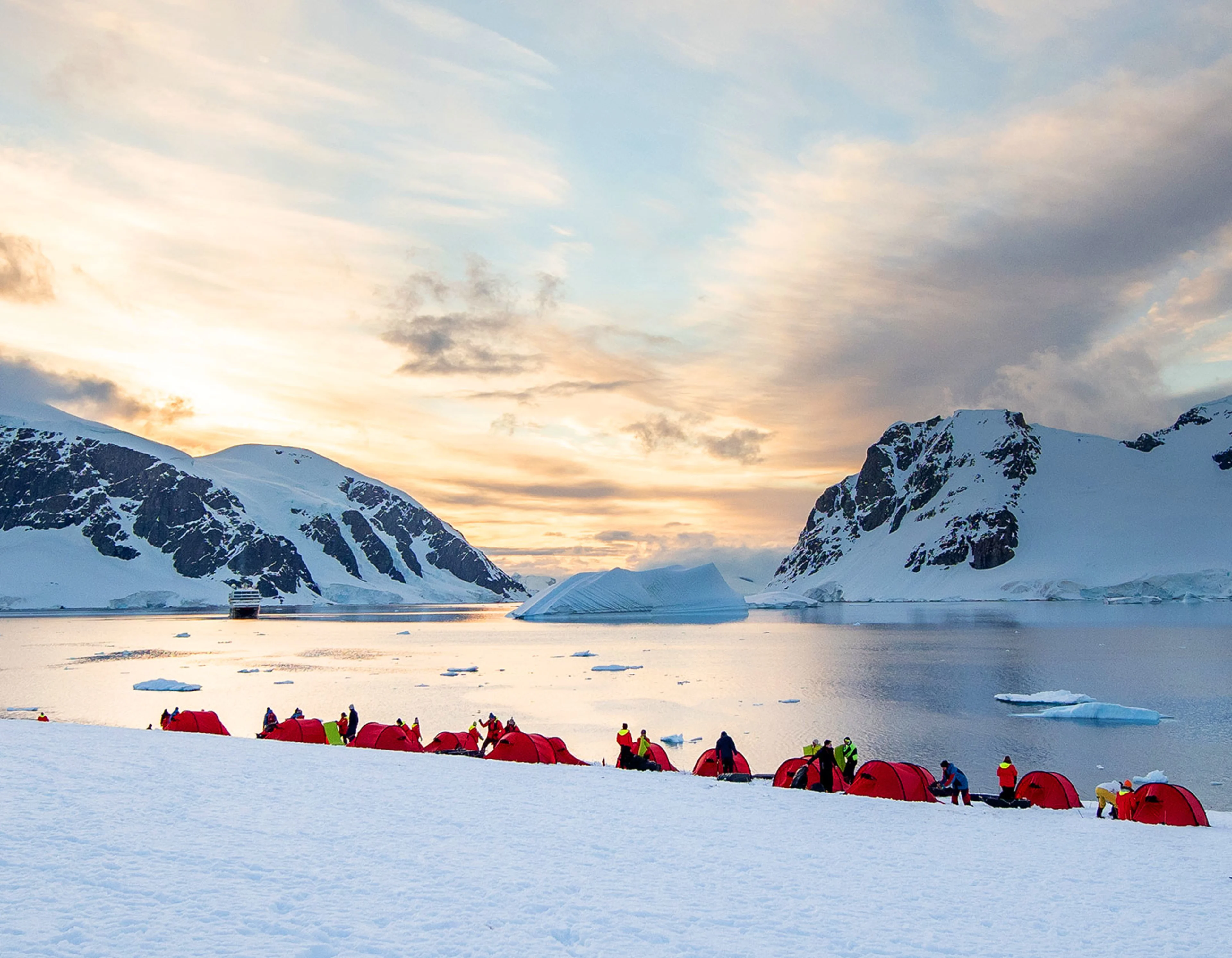 Red tents on the Antarctic Peninsula, with a Sea view.