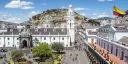 Square with trees and people, surrounded by white buildings in Quito City, Ecuador