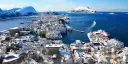 Ålesund in winter from above, houses next to the sea covered in snow.
