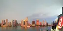 Hurtigruten ship in front of Miami skyline.