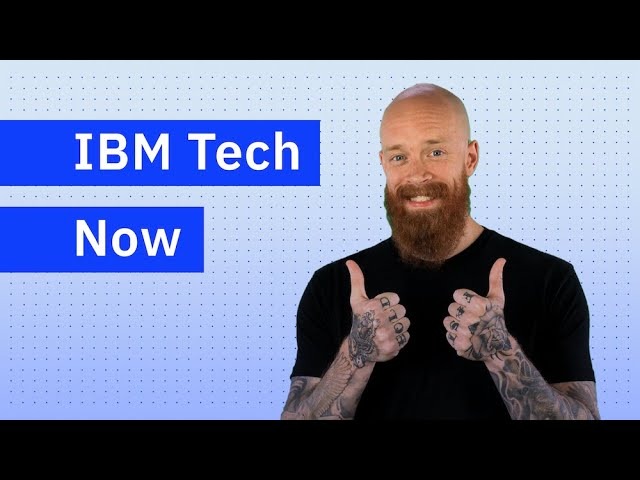 Man smiling next to "IBM Tech Now" sign.
