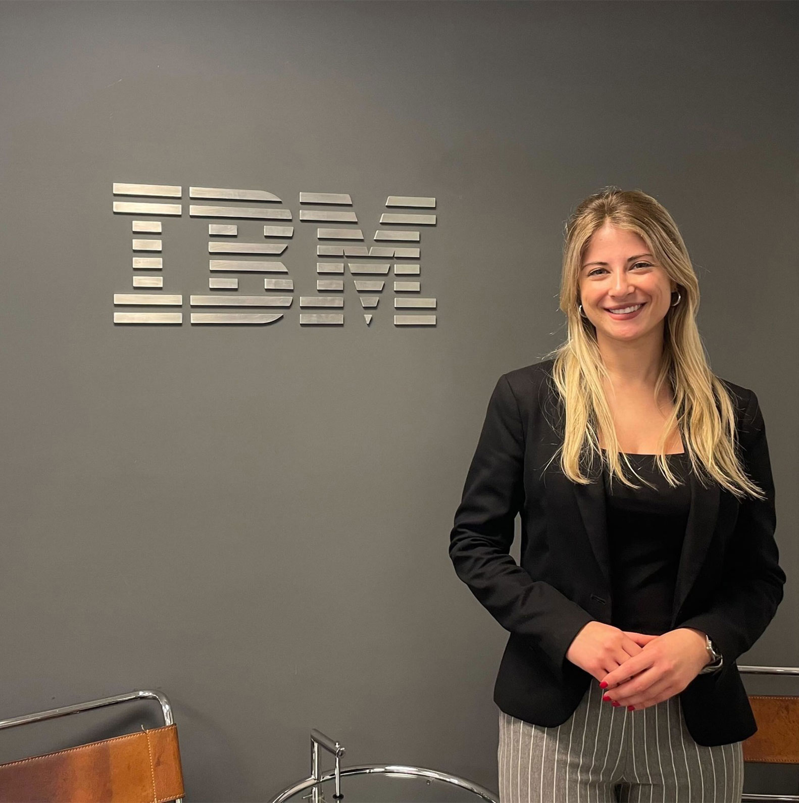 Woman standing, IBM sign behind