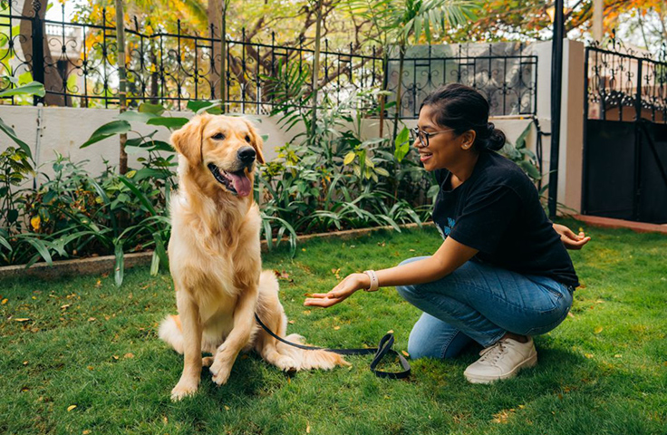 Women playing with her dog at her backyard