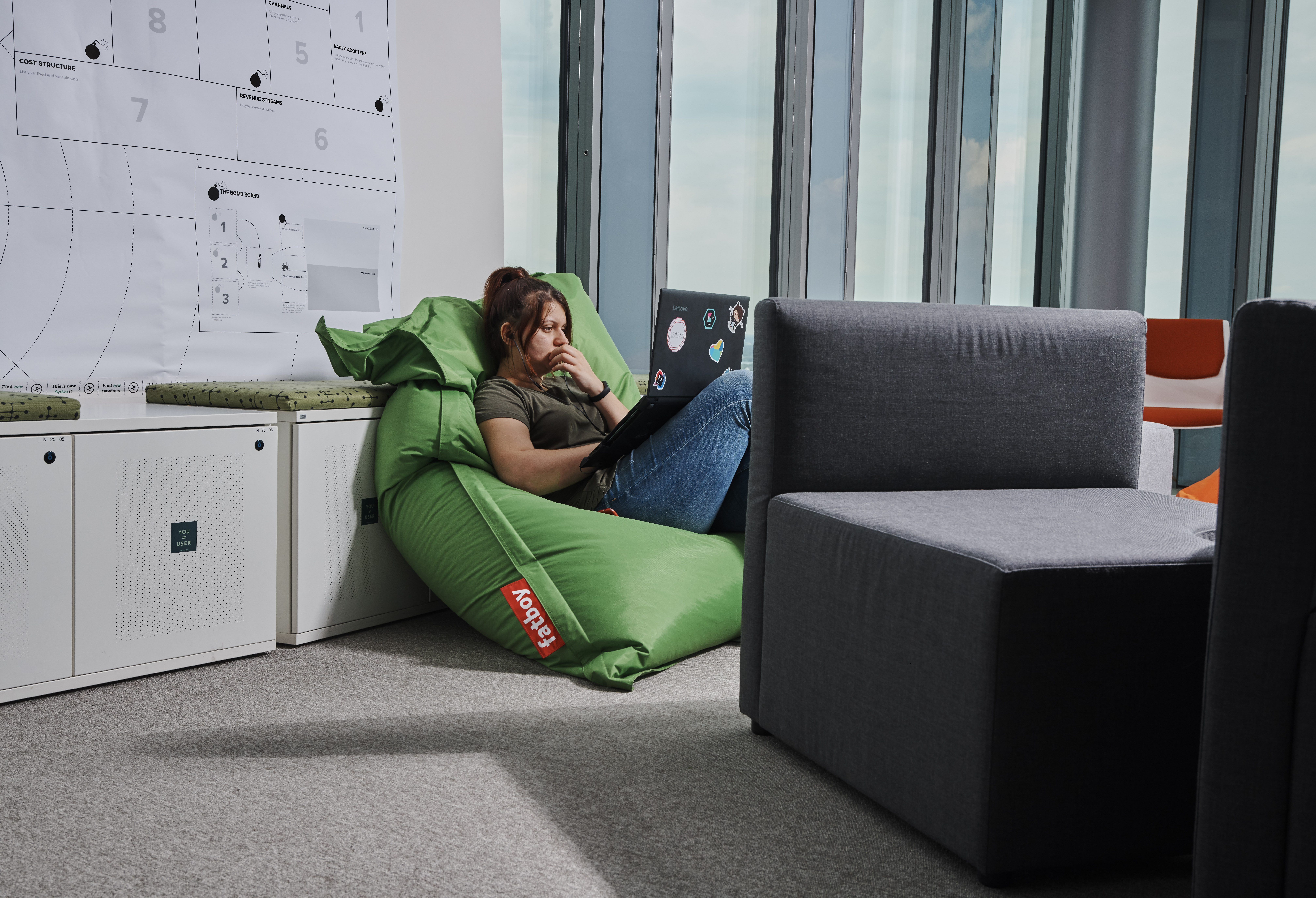 Woman sitting on bean bag with laptop