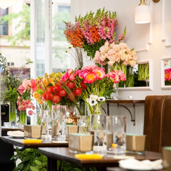 Colorful, fresh flower bouquets in glass vases decorating a bright interior.