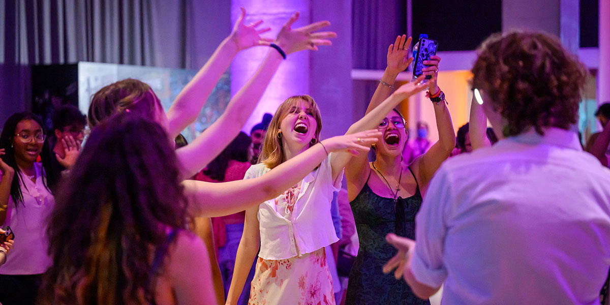 A group of film lovers with their hands in the air