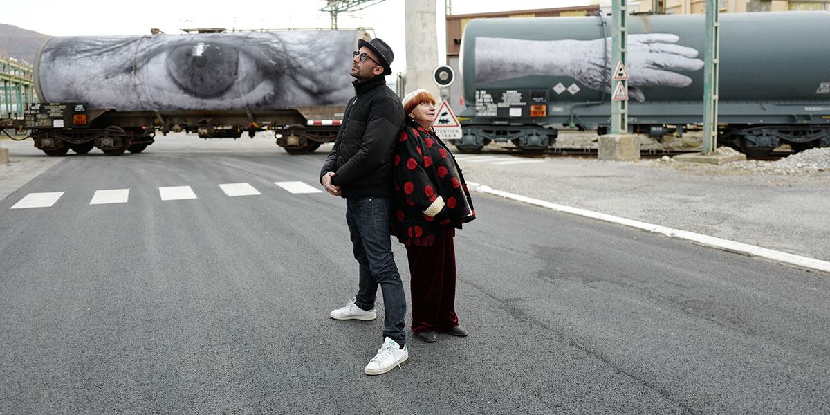 Agnes Varda and standing back-to-back