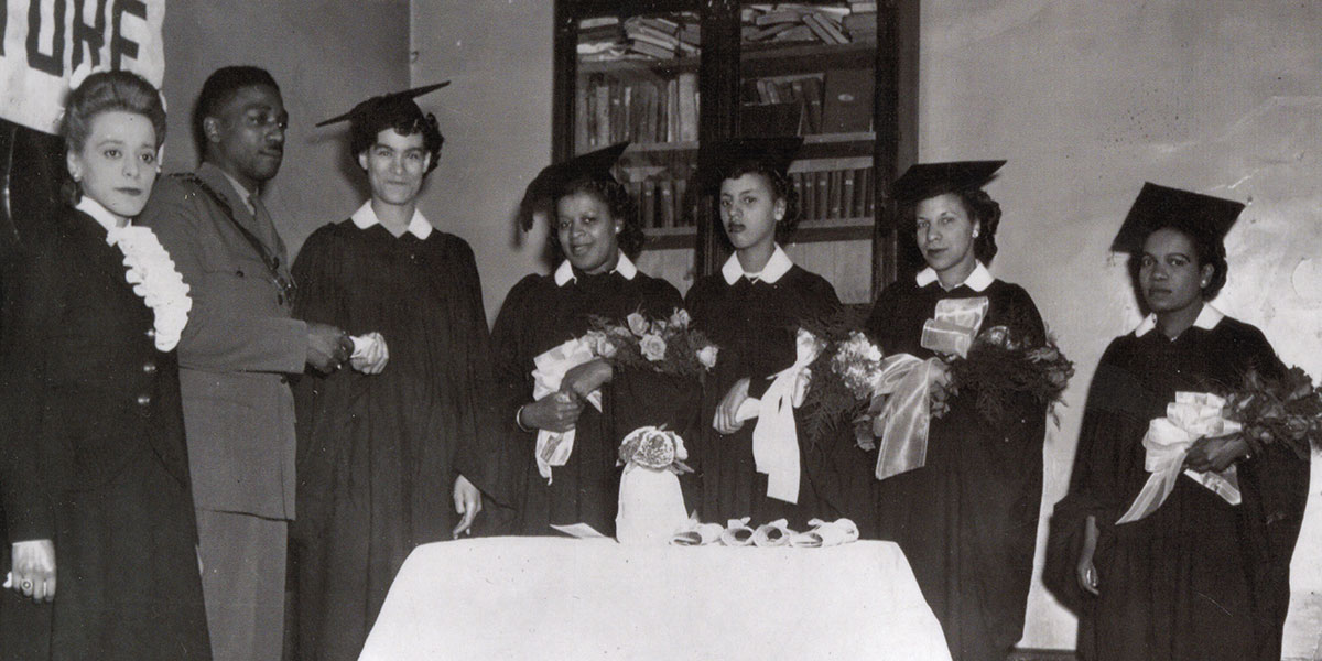 Viola Desmond standing alongside her graduating students.