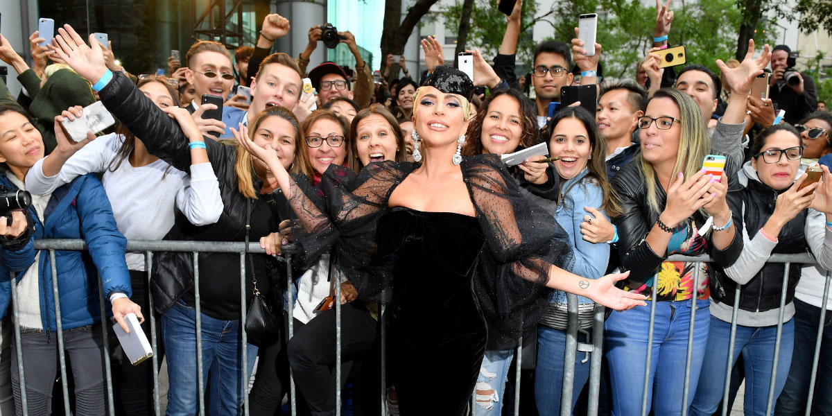 Lady GaGa posing amongst festival goers during a red carpet