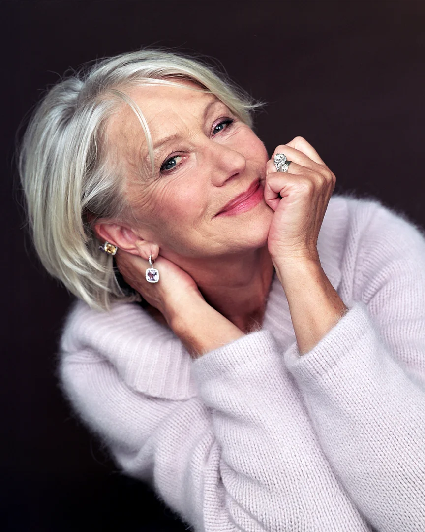Helen Mirren smiling in a white sweater at TIFF