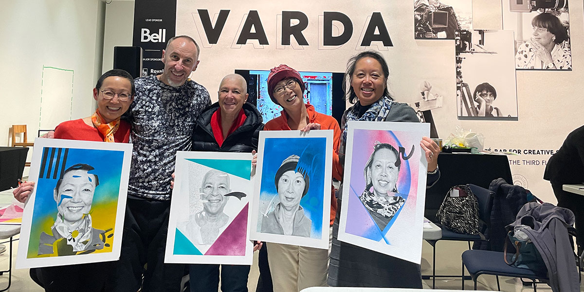 Five people holding up portraits of themselves in the TIFF Lightbox lobby