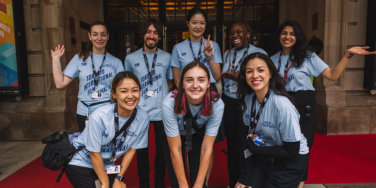 Eight Festival volunteers smiling