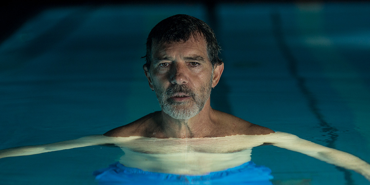 Antonio Bandaras floating in a swimming pool at night