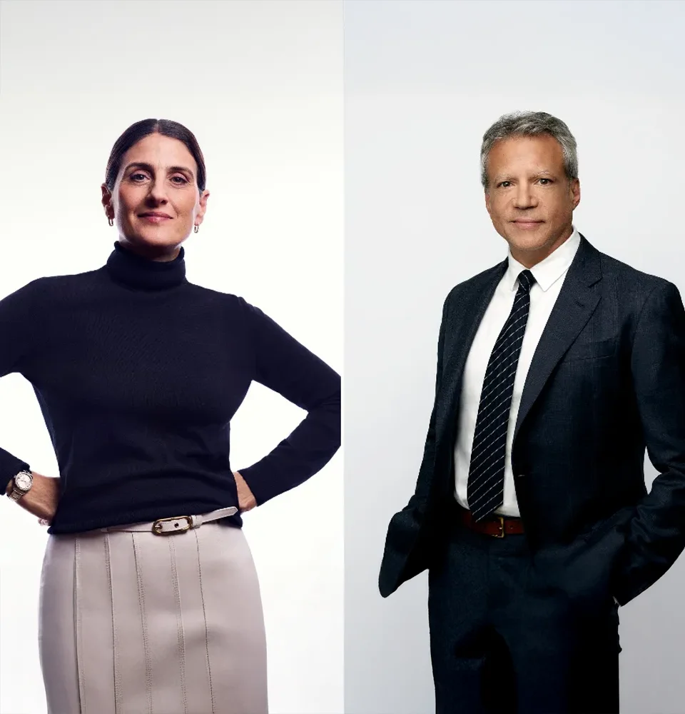 A woman in a black turtleneck and a man in a dark suit pose confidently against white backgrounds.