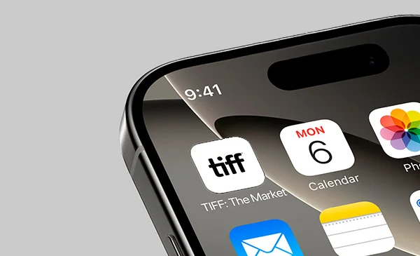 Close-up of an iPhone screen showing the TIFF: The Market app icon alongside Calendar and Photos apps.