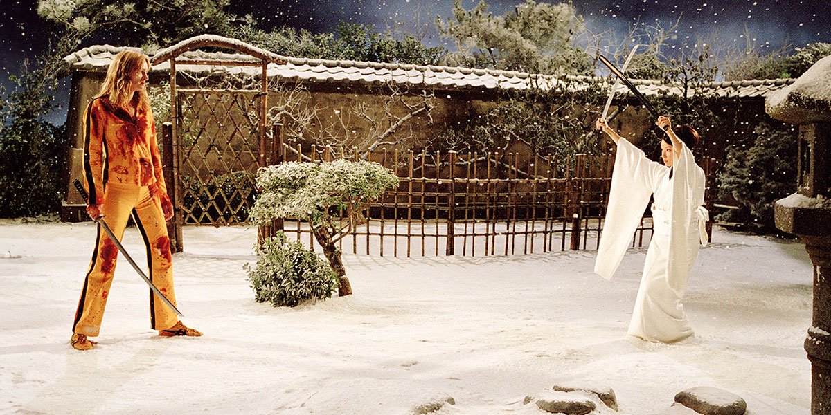 The Bride (Uma Thurman) holding a katana about to fight O-Ren Ishii (Lucy Liu) in the snow covered Japanese garden