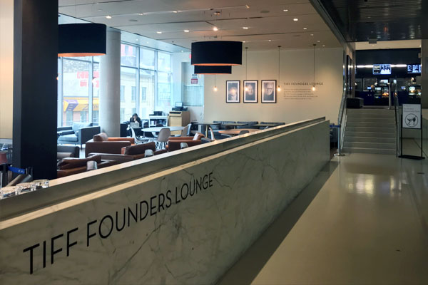 Interior shot of TIFF Founders Lounge with tables and chairs