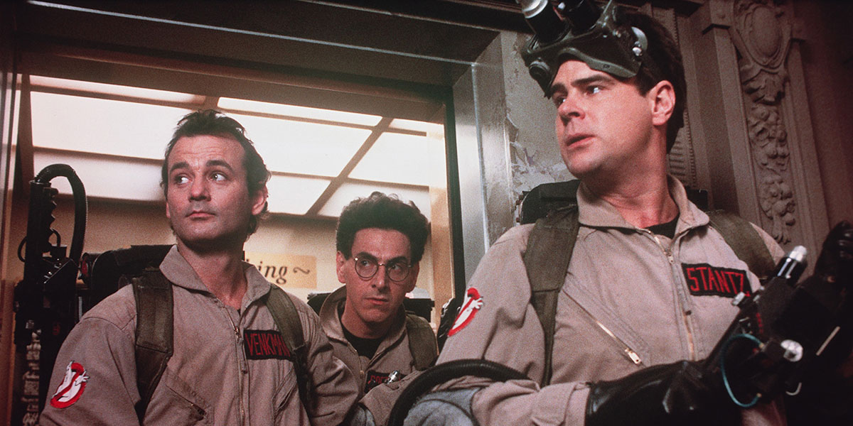 Dan Aykroyd, Bill Murray and Harold Ramis coming out of the doorway dressed in their Ghostbuster uniform