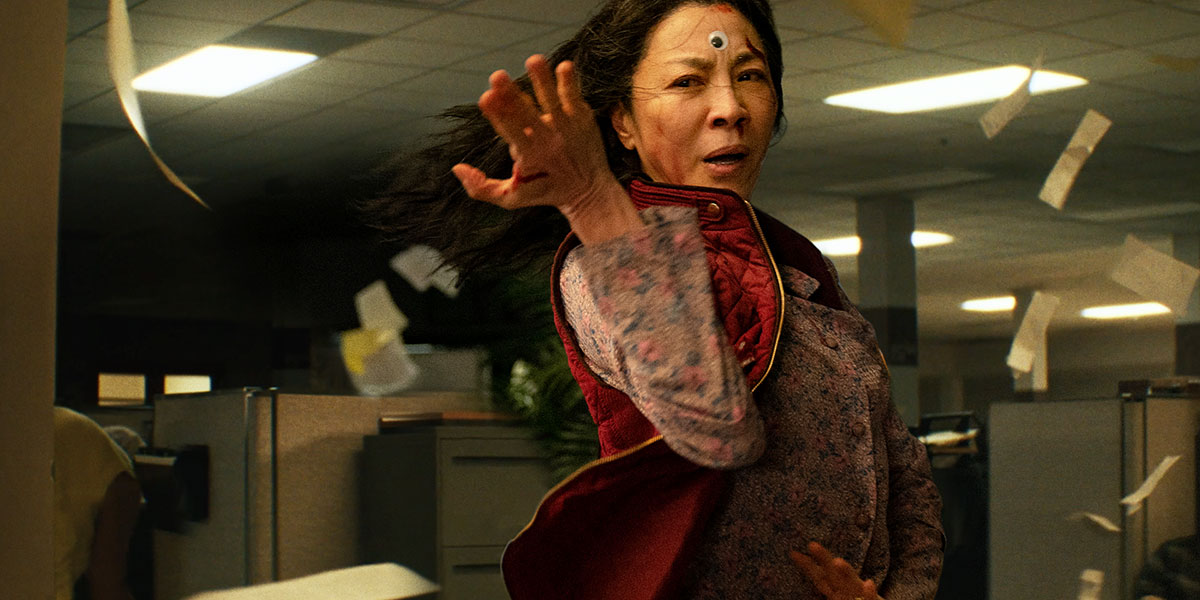 Evelyn (Michelle Yeoh) in midst of a fight with a sticky eye on her forehead