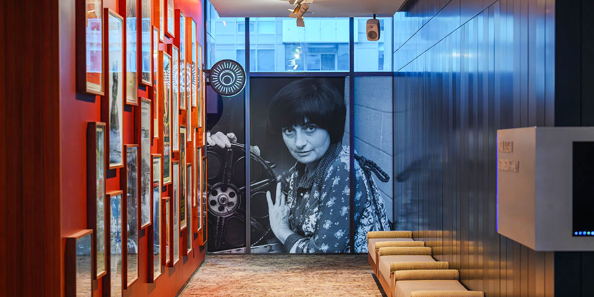 Looking down the hall towards the Varda Lounge with a portrait of Agnes Varda at the end