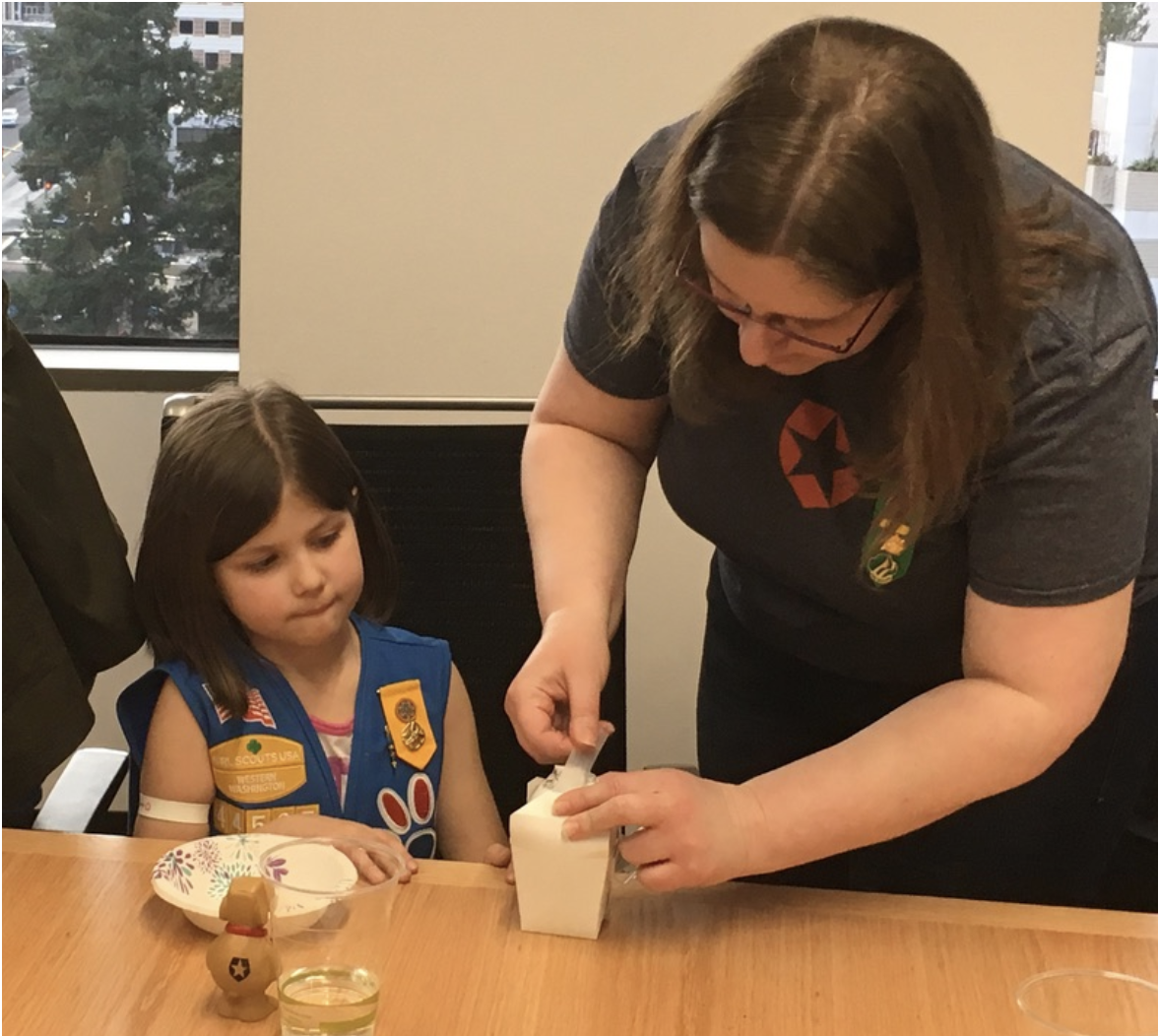 Auth0 employee assists Scouts in the egg drop exercise