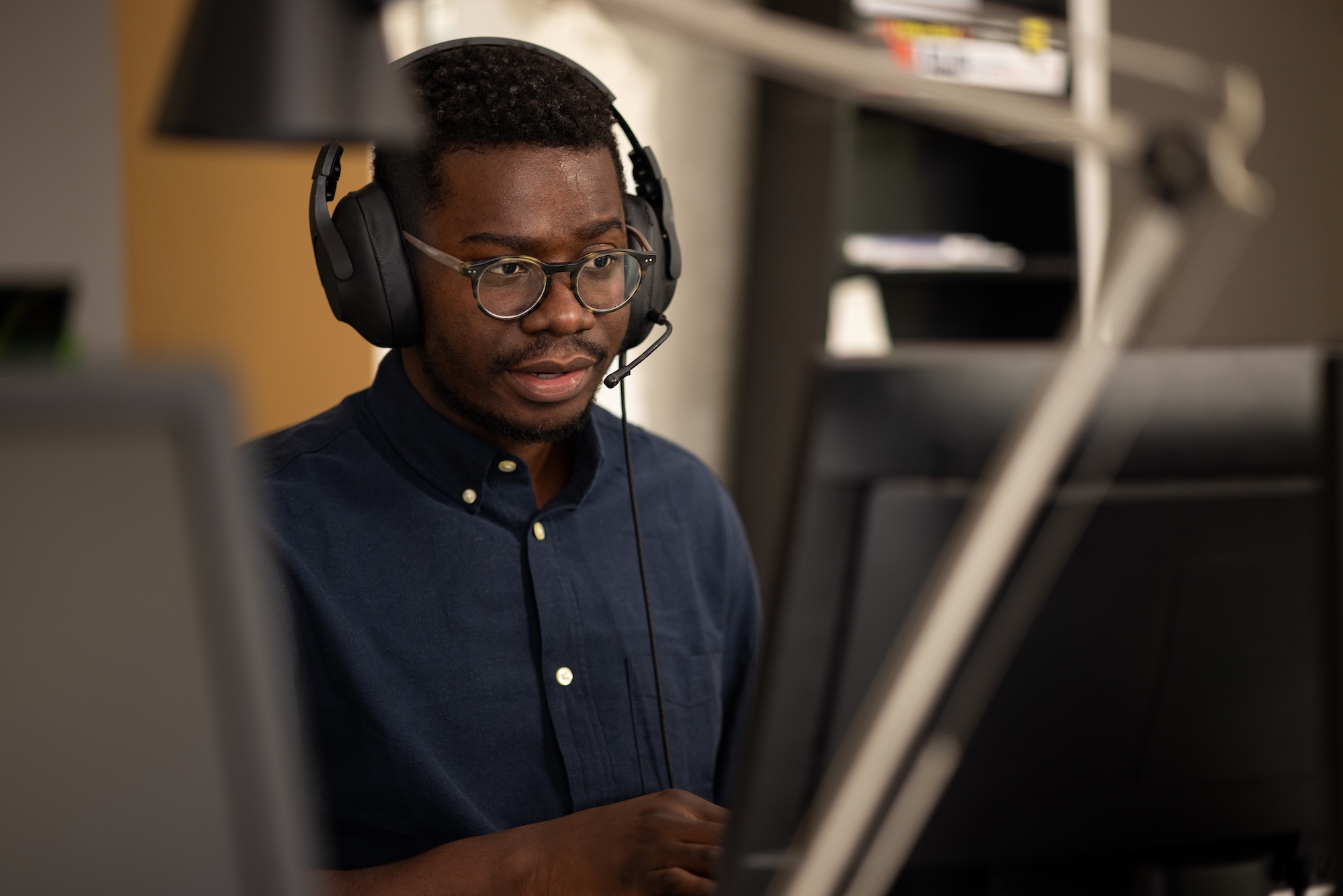Man with a headset at a computer