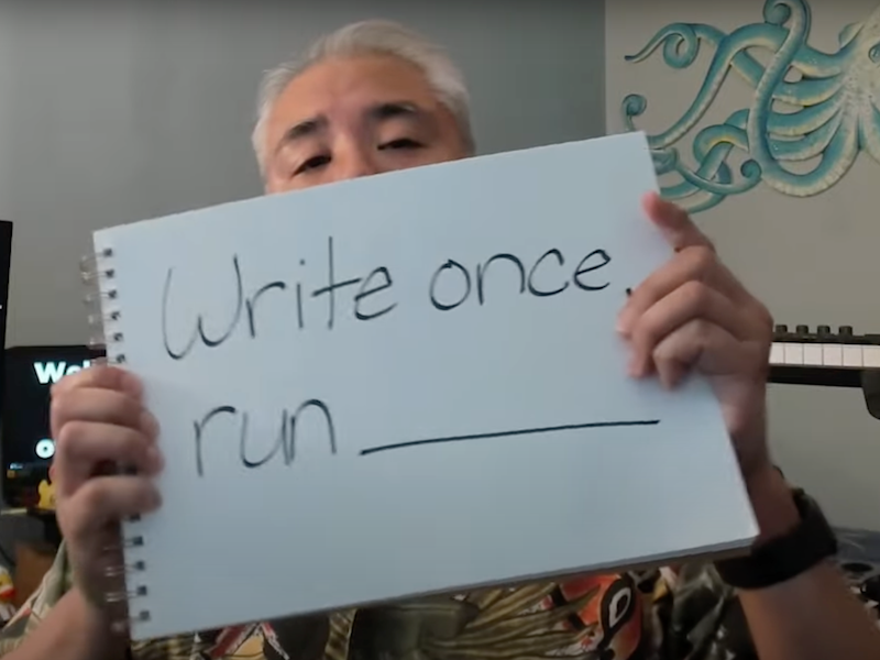 Article author Joey deVilla holding a piece of paper that reads “Write once, run _____.”