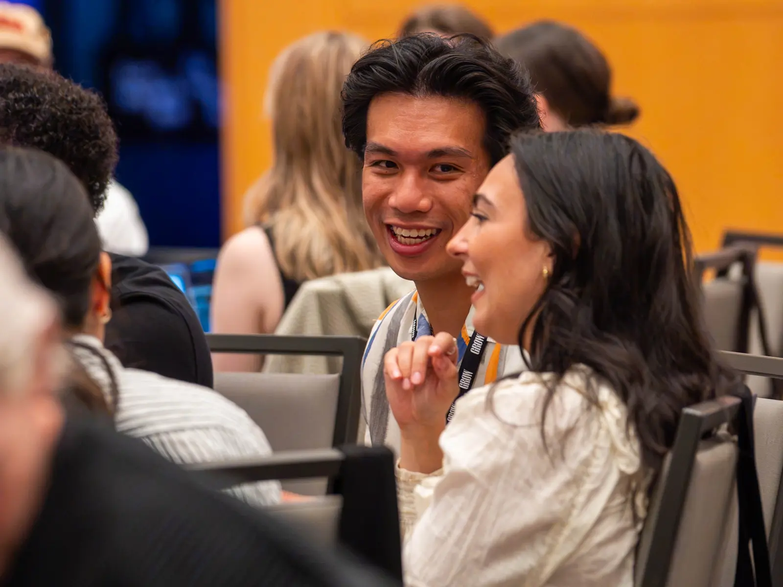 Grow team members talking at a company gathering.
