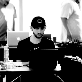 Ferhat Kochan at a laptop.
