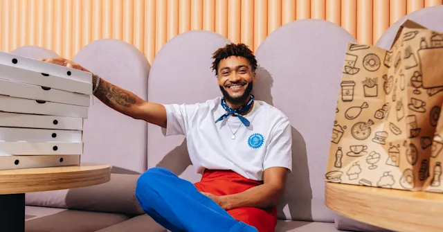 Smiling merchant who has prepared Wolt pickup bags