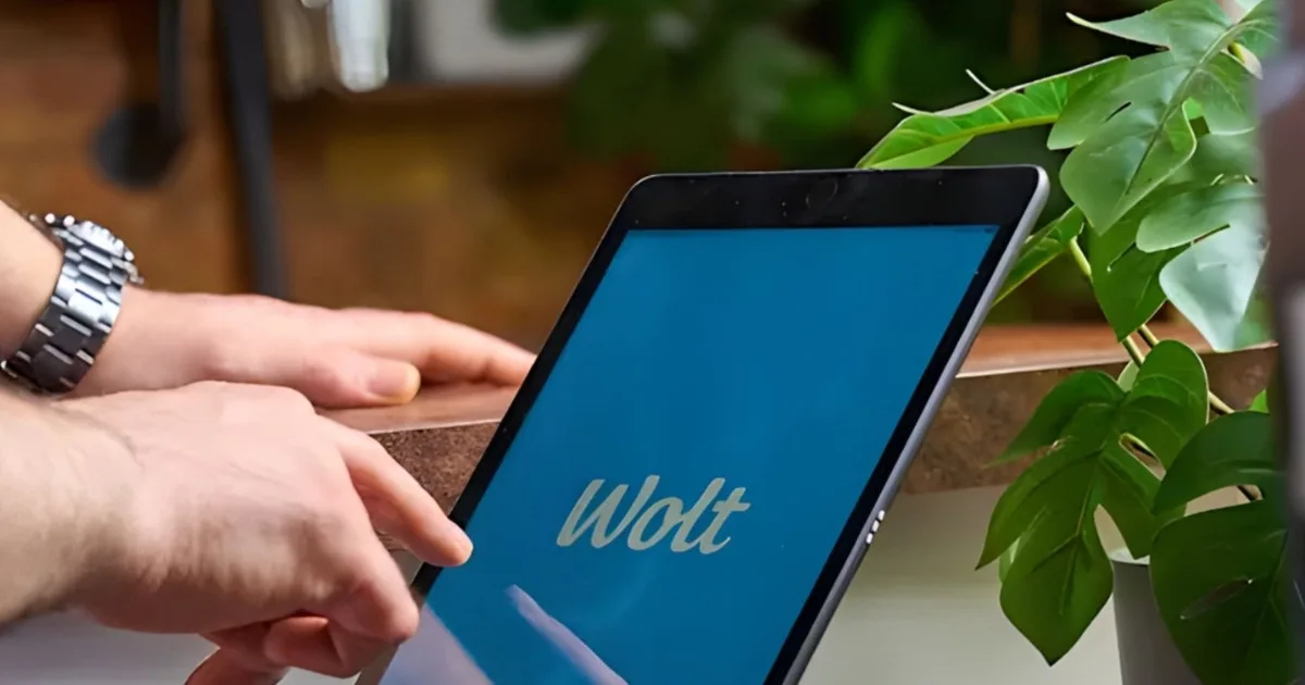 A merchant uses the Wolt app on a tablet to manage paid marketing campaigns, demonstrating how delivery platforms offer affordable advertising tools for restaurants