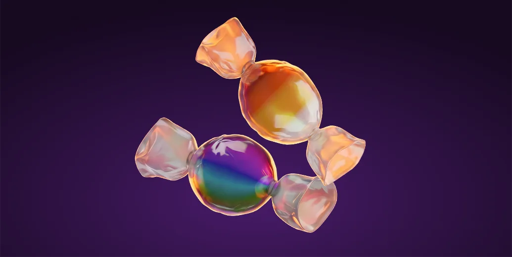 Two shiny wrapped Halloween candies, one orange and one rainbow-colored, on a dark purple background, representing sweets delivered with Wolt.