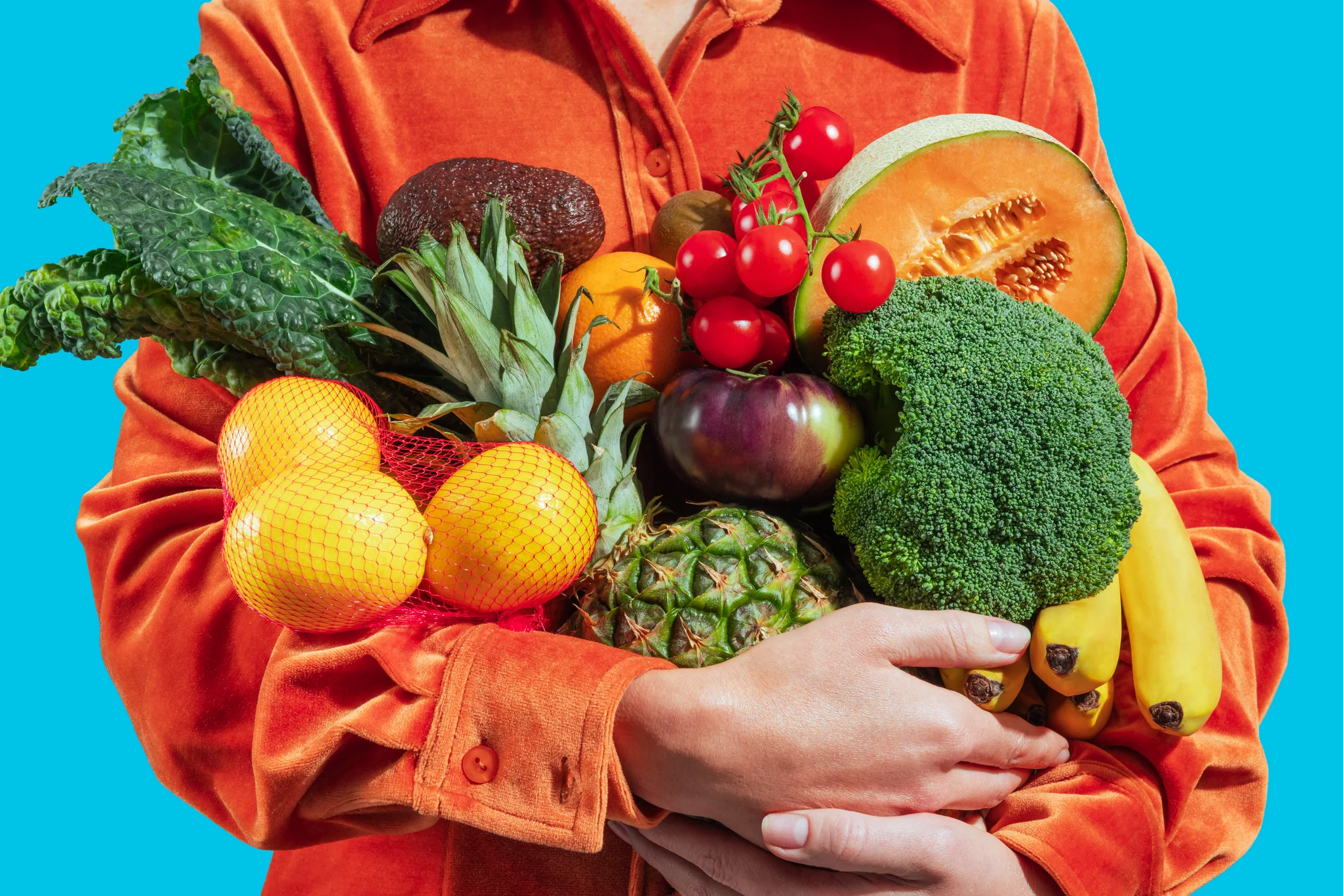 Person in orange holding fresh groceries, used as brand card image for Broly's Market - Albania