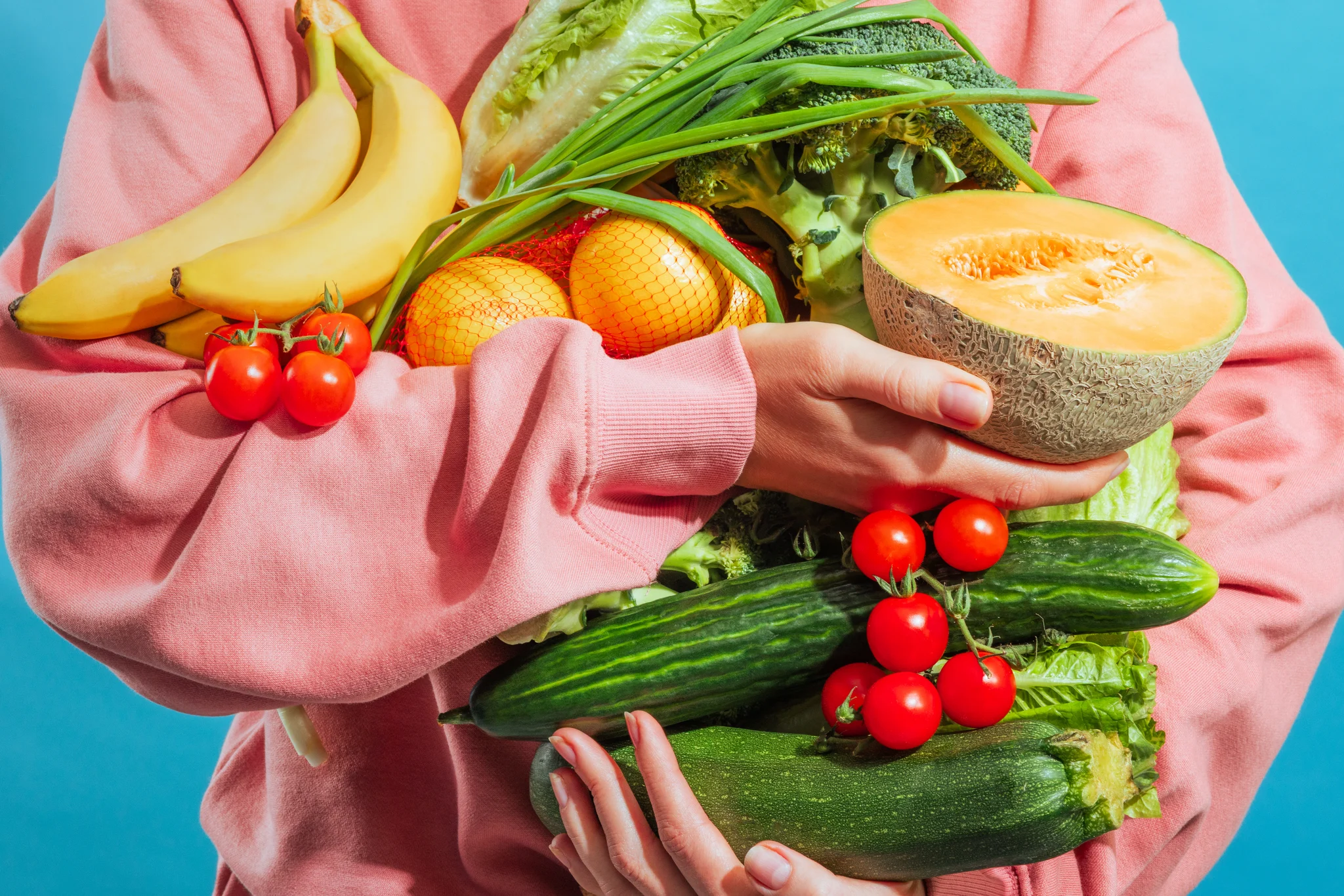 Person in pink holding fresh groceries, used as brand card image for Visi Market - Albania