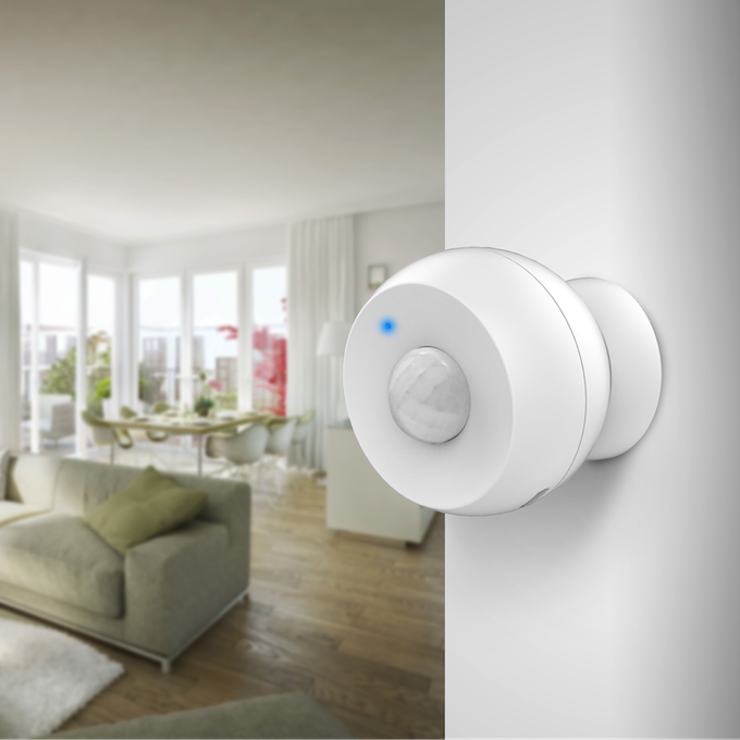 Zooz motion sensor mounted on wall in modern living room