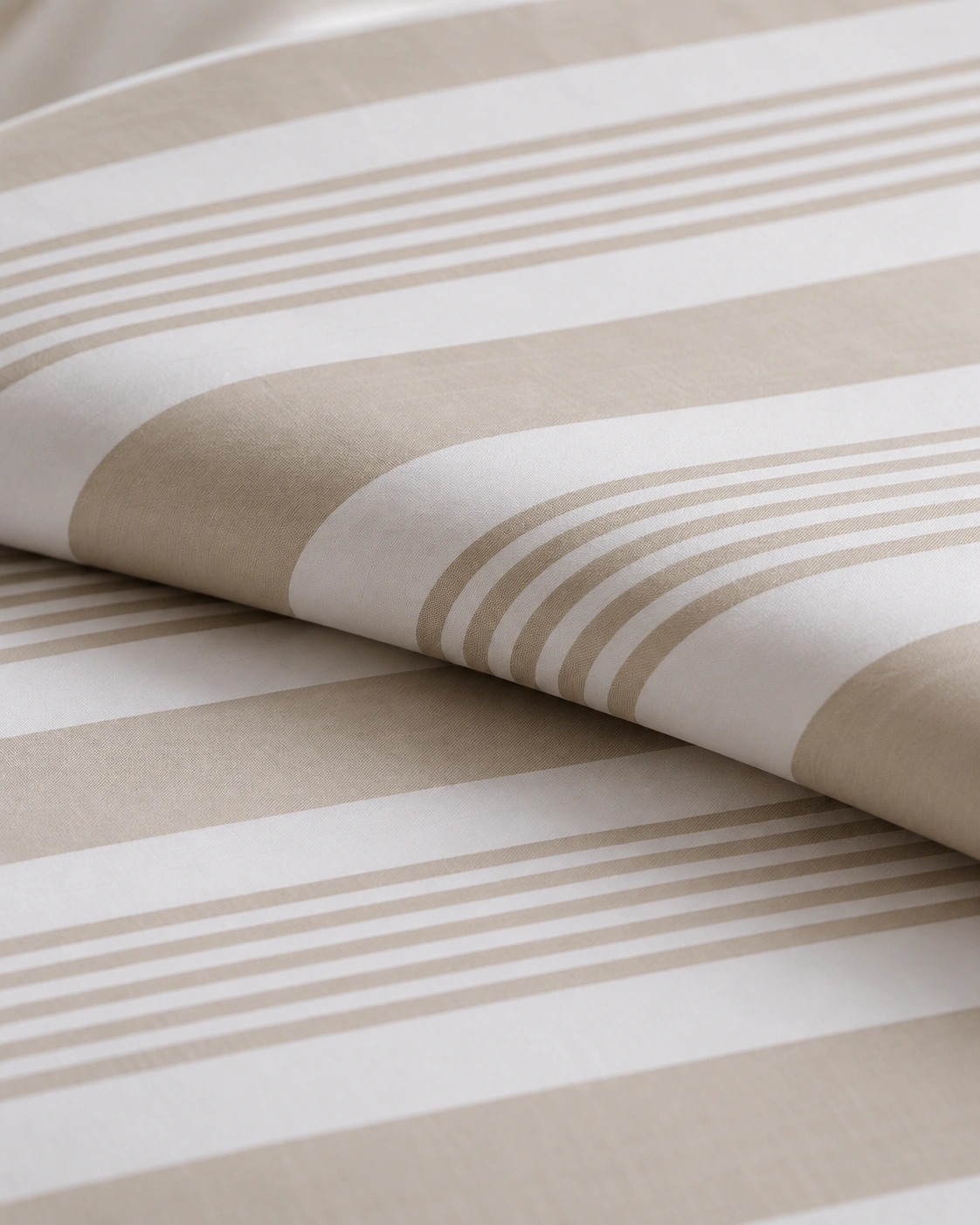 Beige-and-white striped cloth folded over on itself, close