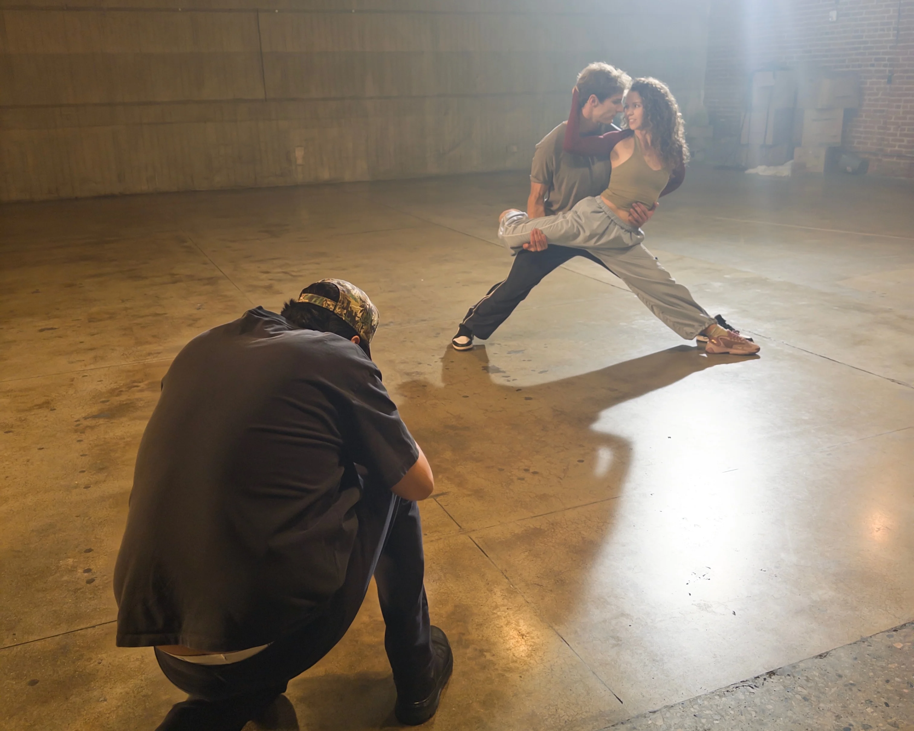 A male and female actor pose for a photograph on a Hollywood set