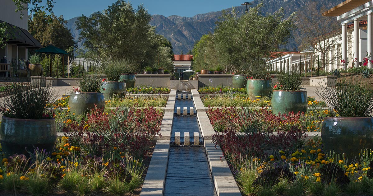 Exterior view of The Huntington Library, Art Museum, and Botanical Gardens in San Marino, California, showing landscaped gardens and historic architecture.