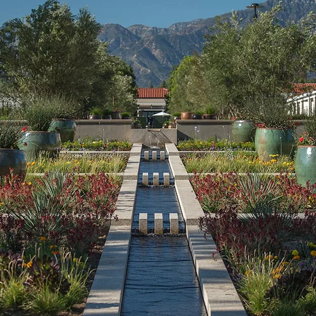 Exterior view of The Huntington Library, Art Museum, and Botanical Gardens in San Marino, California, showing landscaped gardens and historic architecture.