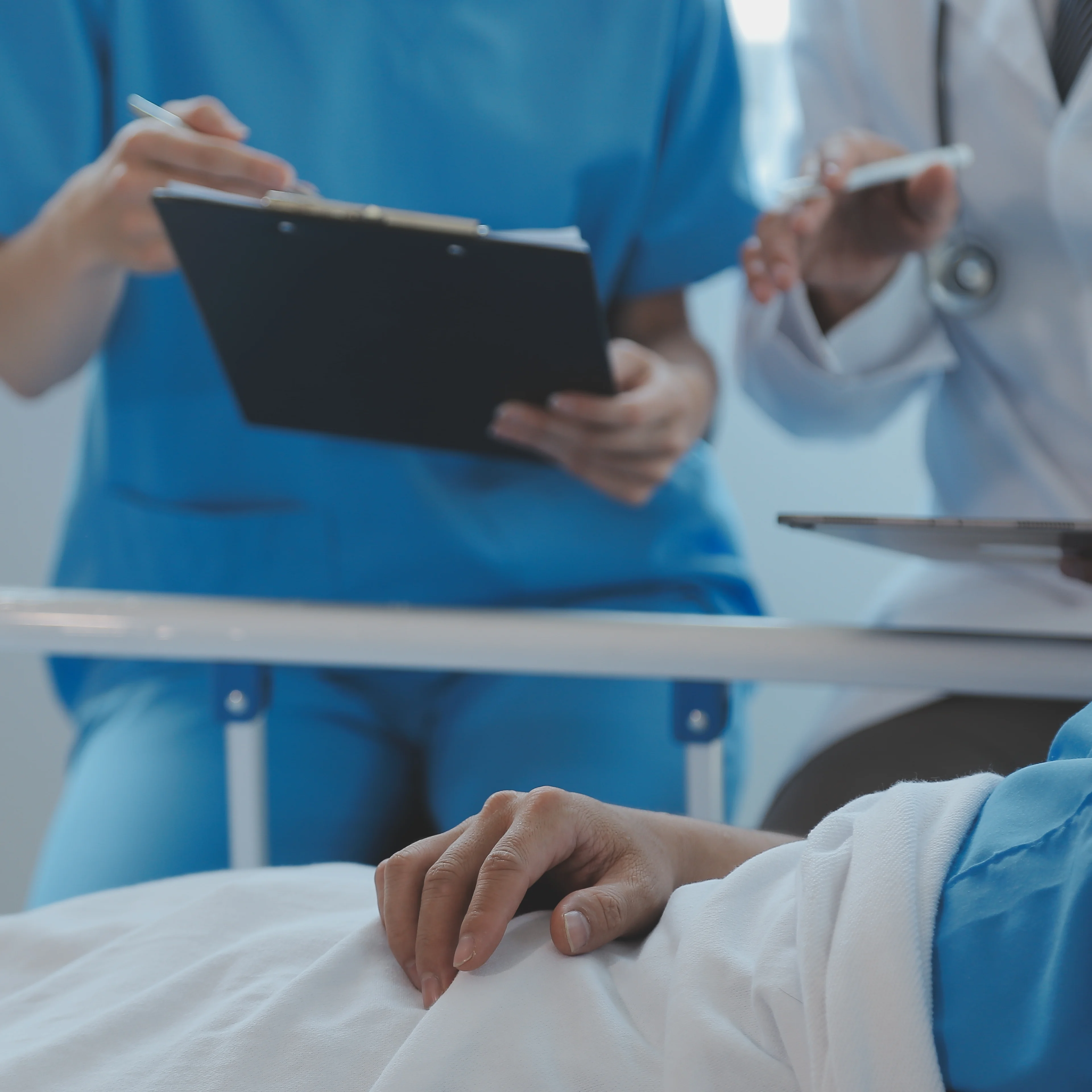 A doctor and a nurse look after a patient in an emergency room.