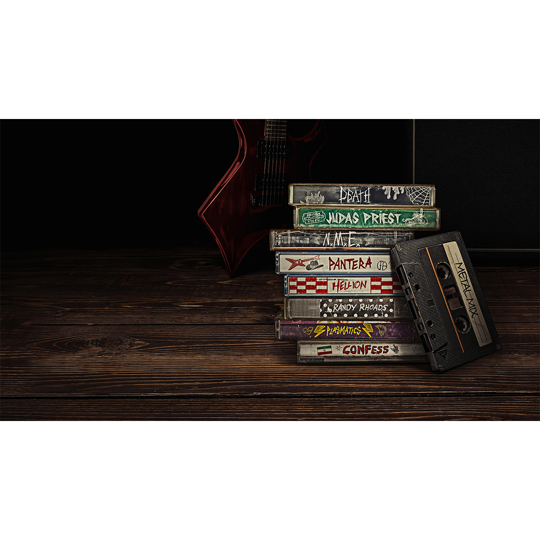 Stack of heavy metal music cassette tapes including Judas Priest and Pantera beside a red electric guitar on wooden surface.