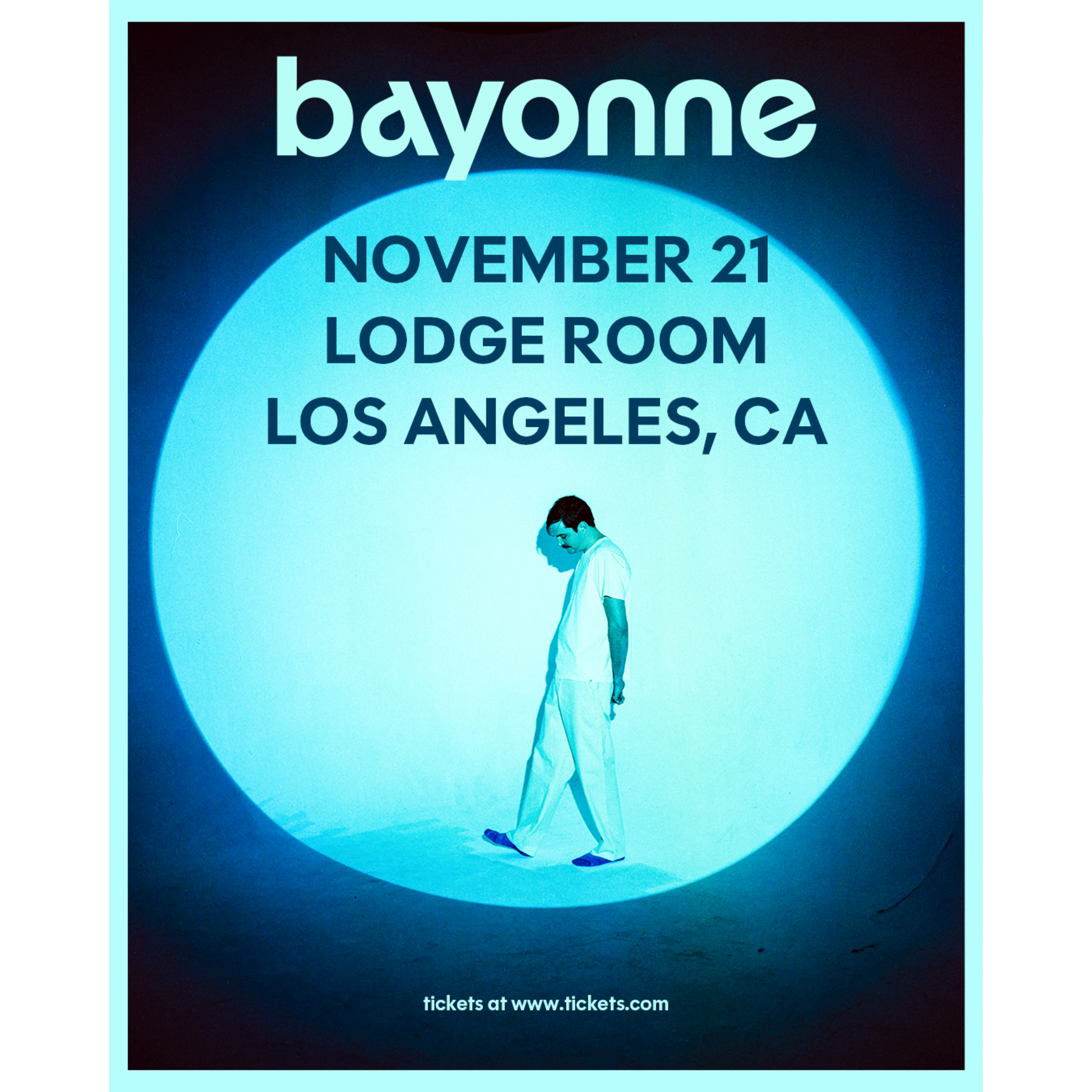 Bayonne concert poster for November 21 at Lodge Room, Los Angeles, CA, featuring a man in white walking in a blue spotlight.