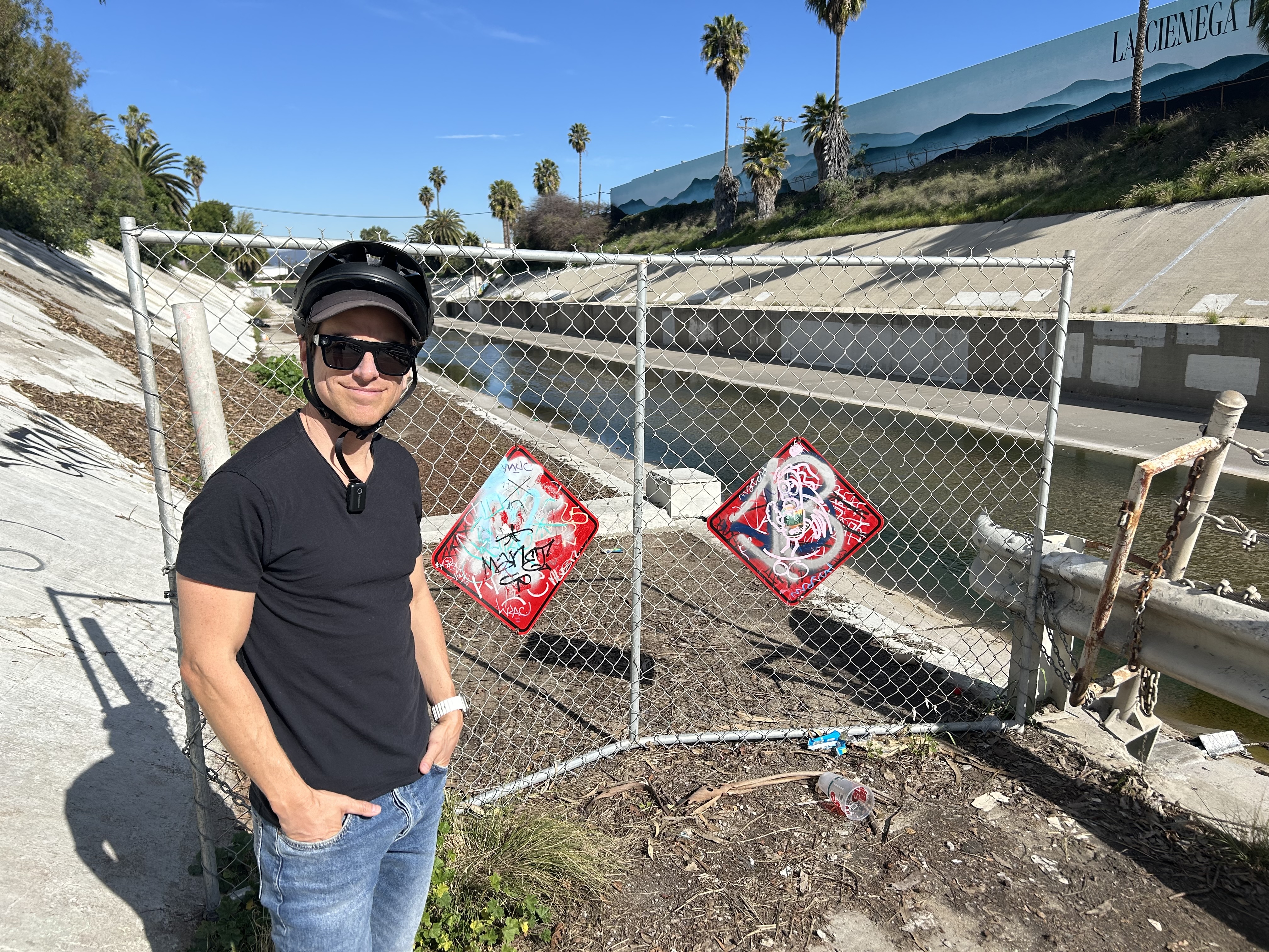 Streets for All's Michael Schneider stands at the gate at the end of the Ballona Creek Bike Path