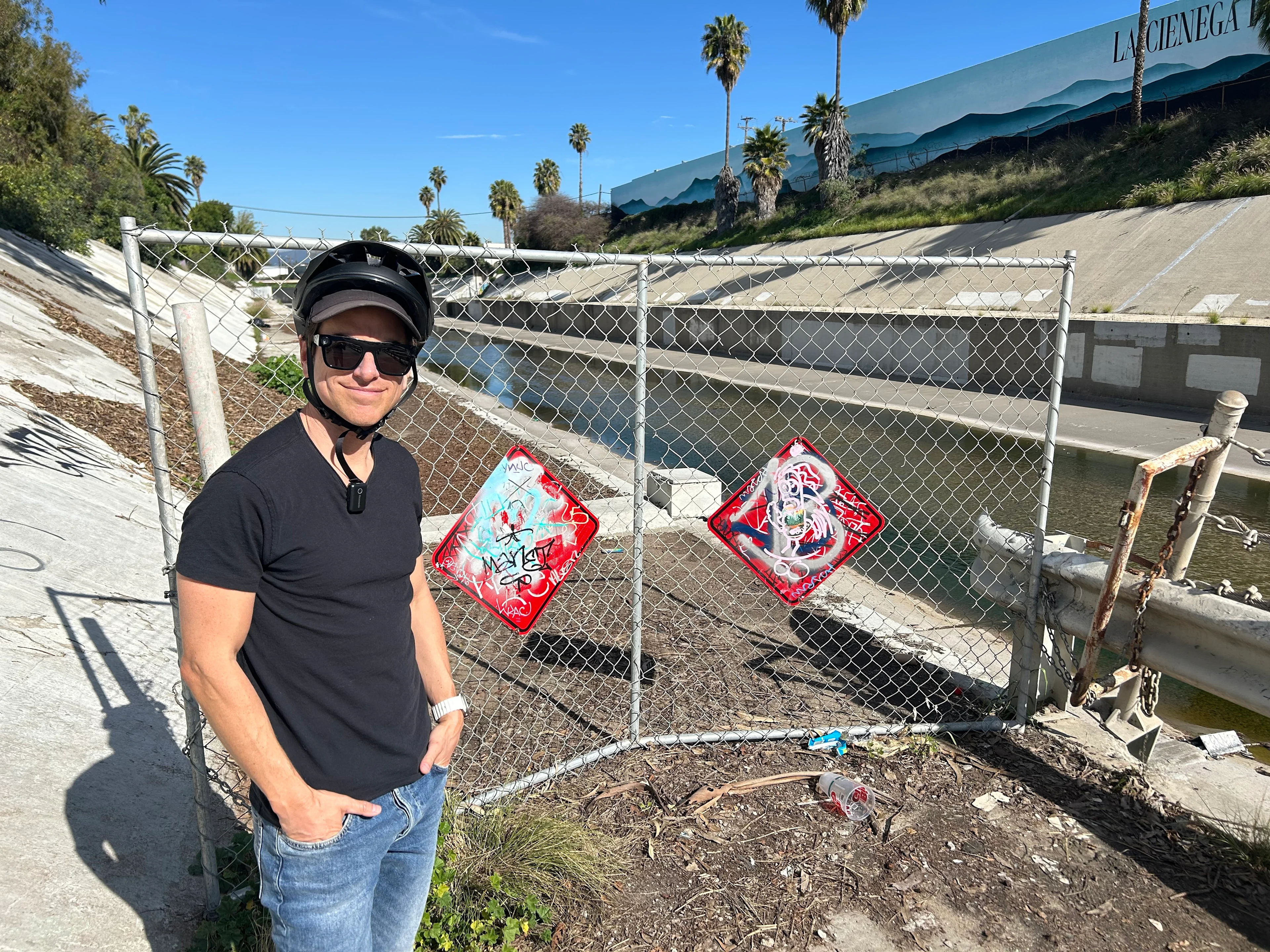 Streets for All's Michael Schneider stands at the gate at the end of the Ballona Creek Bike Path