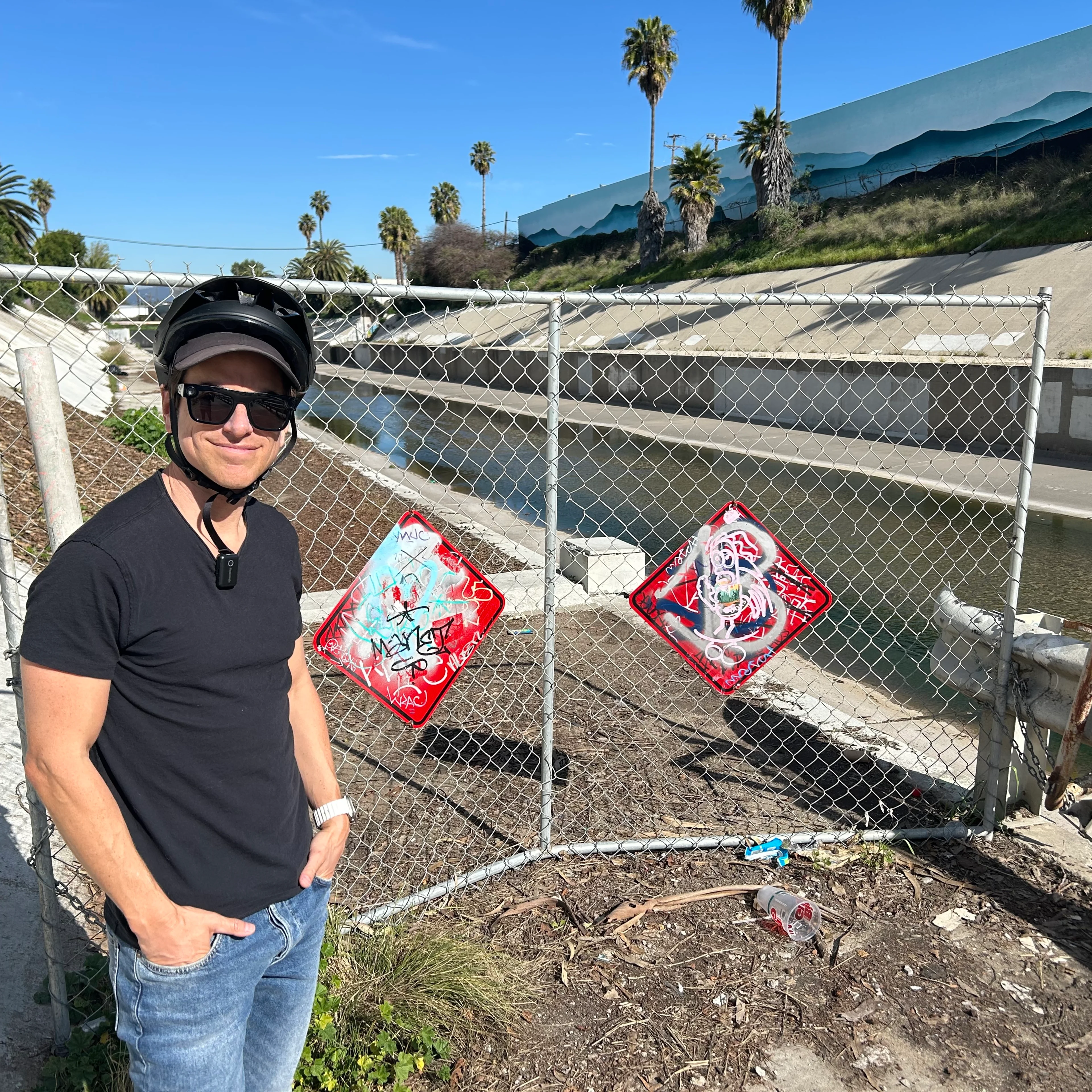 Streets for All's Michael Schneider stands at the gate at the end of the Ballona Creek Bike Path