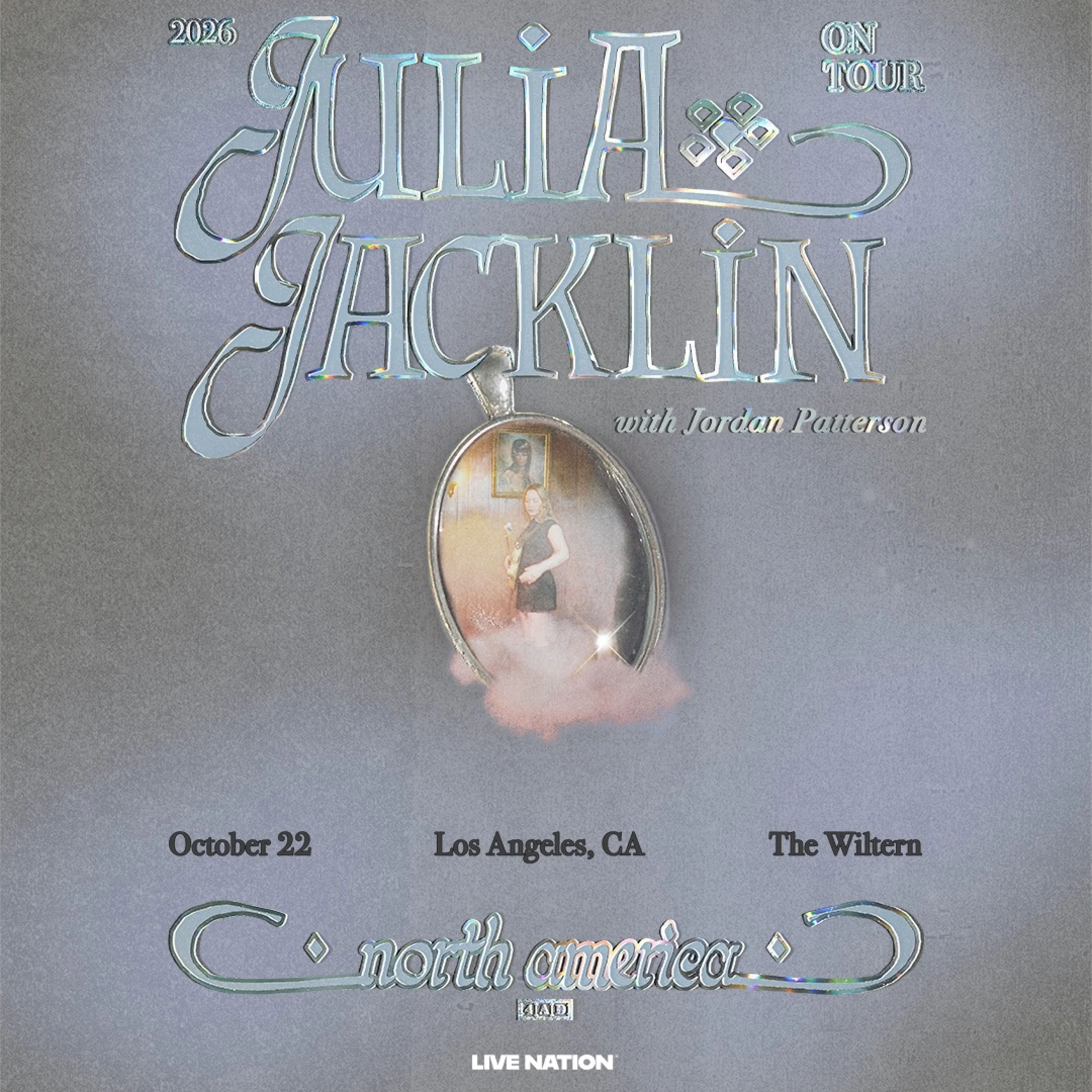 Julia Jacklin 2026 North America tour poster featuring a silver locket, holographic text, October 22 at The Wiltern, Los Angeles.